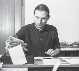  ??  ?? Nathan van der Meiden, one of the students helping archivists with the reconstruc­tion, works on the project July 16 in Berlin. It may take centuries to complete the massive reassembly task.