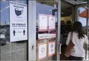  ?? LM OTERO — THE ASSOCIATED PRESS FILE ?? A customer enters a store with a face mask required sign displayed in Dallas on Tuesday.