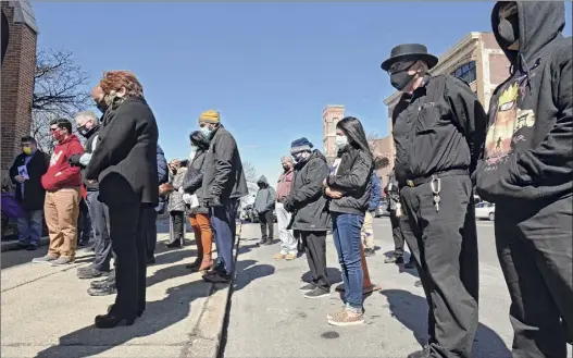  ?? Lori Van Buren / Times Union ?? Community and business members participat­e in a moment of silence as church bells ring for a full minute outside Capital District Latinos Church to remember the lives lost to COVID-19 on Friday in Albany.