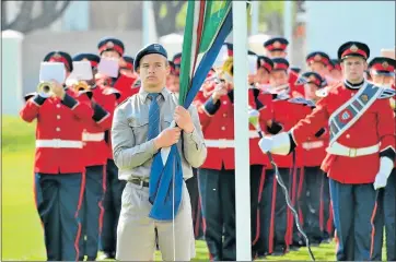  ?? Picture: IVOR MARKMAN ?? RETREAT CEREMONY: The South African flag is lowered during the annual retreat (flag lowering) ceremony held at Grey High School. The cadet parade carries on a centuries-old military practice of changing the guard and beating
the retreat