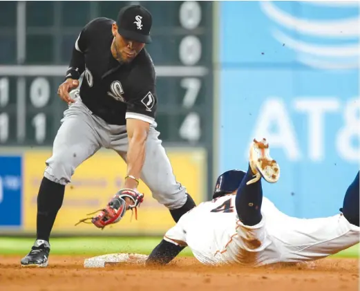  ?? AP ?? Sox second baseman Yoan Moncada ( applying a late tag on a stolen base Saturday by the Astros’ George Springer) hasn’t made an error in the last eight games.