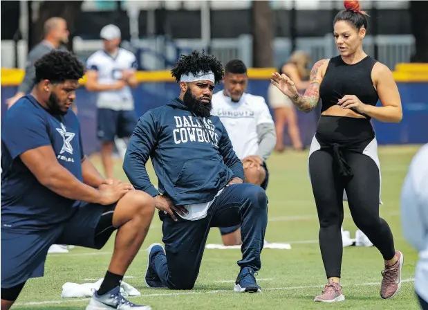 ?? GUS RUELAS / THE ASSOCIATED PRESS FILES ?? Dallas offensive tackle La’el Collins, left, and running back Ezekiel Elliott listen to yoga instructor Stacey Hickman at training camp.