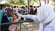  ?? PHOTO: ANI ?? Medics conduct thermal screening of migrants arrived from Mumbai and waiting to board buses to reach their hometowns during a government-imposed nationwide lockdown as a preventive measure against the COVID-19 coronaviru­s, in Prayagraj on Wednesday.