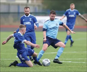  ?? ?? Enniskille­n Town’s Duwayne Mcmanus is tackled in the middle of the park.