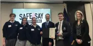  ??  ?? PJP Senior Hank McNeil, who created a video for Safe2Say Something as part of a PSA contest, accepts the award from Attorney General Josh Shapiro in Harrisburg.