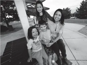  ?? DAVID ZALUBOWSKI/ASSOCIATED PRESS ?? Laura Peniche, right, joins her children 11-year-old Katalina, 4-year-old Athena, and 6-year-old Leonardo, at a playground Tuesday in Thornton, Colo. Peniche, 34, came from Mexico as a teen and has protection from deportatio­n under the Deferred Action for Childhood Arrivals program. When she was struggling financiall­y this past year, she was too scared to apply for government food assistance.