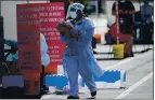  ?? LYNNE SLADKY — THE ASSOCIATED PRESS ?? A health care worker is on duty at a COVID-19 testing site at a health center in Homestead, Fla., on Monday.