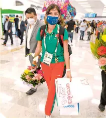  ??  ?? La fondista Andrea Ramírez tuvo una cálida bienvenida por parte de sus familiares en el aeropuerto.