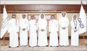  ?? ?? QNB Group Chief Executive Officer Abdulla Mubarak Al Khalifa and Ajlan & Holding Chairman Ajlan Bin Abdulaziz Alajlan with senior officials from both companies at the agreement signing ceremony.