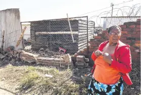  ?? Picture: Jacques Nelles ?? ACCIDENT SCENE. Khambule stands where a man who was allegedly drunk crashed into her house.