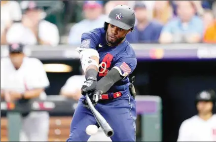  ??  ?? American League’s Cedric Mullins, of the Baltimore Orioles, connects for a base hit during the fifth inning of the MLB All-Star baseball game in Denver. American League won 5-2.(AP)
