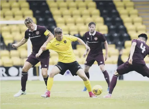  ??  ?? 0 Livingston debutant Joshua Peters is challenged by Christophe Berra, left, and Krystian Nowak of Hearts.