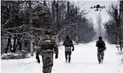  ?? AP ?? Ukrainian soldiers follow a drone close to the frontline near Avdiivka, Donetsk region, Ukraine, on Friday.