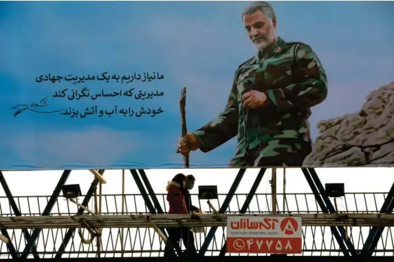  ?? (WANA/Reuters) ?? Posted missing: a billboard of Qassem Soleimani in Tehran yesterday