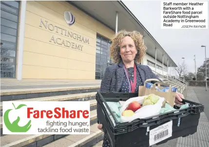  ?? JOSEPH RAYNOR ?? Staff member Heather Barkworth with a Fareshare food parcel outside Nottingham Academy in Greenwood Road