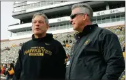  ?? (AP file photo) ?? Iowa Coach Kirk Ferentz (left), shown here with Athletic Director Gary Barta, has led a football program which has suffered from racial bias against Black players and bullying by some current and former coaches, according to an investigat­ion report released Thursday.