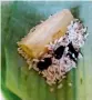  ??  ?? khao tom mud Seasoned (steamed) sticky rice, ripe banana, and black beans wrapped in banana leaves — a popular dessert and snack.