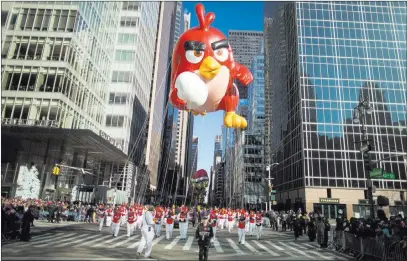  ?? Andres Kudacki ?? The Associated Press A balloon of Red from “Angry Birds” floats down Sixth Avenue during the Macy’s Thanksgivi­ng Day Parade in New York on Thursday.