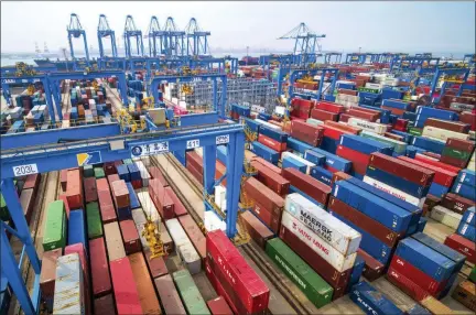  ?? CHINATOPIX VIA AP ?? Containers are piled up at a port in Qingdao in east China’s Shandong province. China’s imports from the United States plunged 31.4% in June from a year earlier amid a tariff war with Washington, while exports to the U.S. market sank 7.8%, Customs data showed Friday.