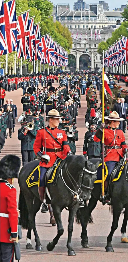  ?? ?? The Mounties get their moment: In their famous red tunics and stetsons, members