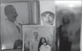  ?? Robert Gauthier ?? A LIGHTED candle is surrounded by photos of Jose de la Trinidad, who was shot and killed in November 2012 during a traffic stop in Compton.