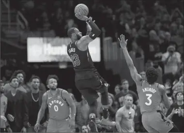  ?? The Associated Press ?? RISE ABOVE: Cavaliers forward Lebron James (23) hits the game-winning runner over OG Anunoby (3) off the glass for a 105-103 win over the Toronto Raptors Saturday in Game 3 of their second round NBA playoff series in Cleveland.