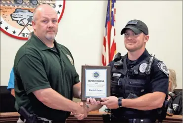  ?? Jeremy stewart ?? Rockmart Police Chief Randy Turner (left) congratula­tes officer Daniel Jones for being named the department’s Officer of the Year by the Exchange Club of Cedartown during a meeting of the Rockmart City Council on Tuesday, Aug. 17.