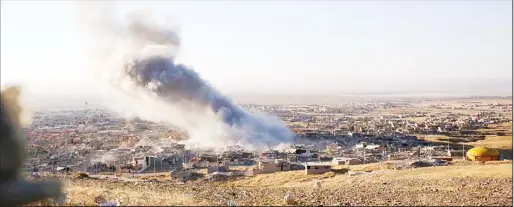  ??  ?? Smoke believed to be from an airstrike billows over the northern Iraqi town of Sinjar on Nov 12. Kurdish Iraqi fighters, backed by the US-led air campaign, launched an assault Thursday aiming to retake the strategic town of Sinjar, which the Islamic...