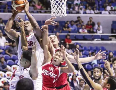  ??  ?? Barangay Ginebra San Miguel’s Justin Brownlee, left, powers his way to the basket against Kia Picanto defenders in the first half of their game in the PBA Governors' Cup yesterday at the Smart Araneta Coliseum. Ginebra won 120-99. (Rio Leonelle Deluvio)