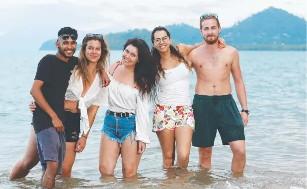  ?? Picture: BRENDAN RADKE ?? TROPICAL FUN: Backpacker­s Amay Rathod from Wales, Mel Morier from Croatia, Paulina Carcamo from Chile, Solange Martinsen from Chile and Lucas Pepel from Germany at Palm Cove.