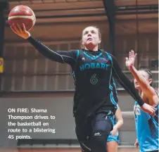  ??  ?? ON FIRE: Sharna Thompson drives to the basketball en route to a blistering 45 points.