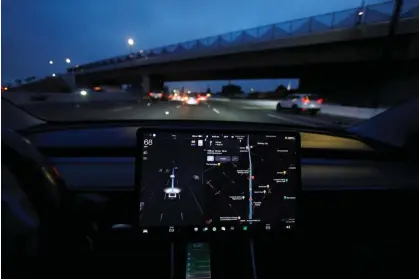  ?? ?? A Tesla model 3 drives on autopilot along the 405 highway in Westminste­r, California, in 2022. Photograph: Mike Blake/Reuters