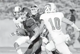  ?? Michael Wyke / Houston Chronicle ?? New Caney’s Jordan Cooper (10) finds a hole to run for a touchdown between Porter’s Kaleb Bailey, left, and Avery Hernandez in the second half.