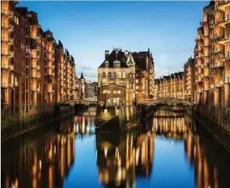  ?? Andreas Meichsner / The New York Times ?? The water castle, center, in the warehouse district of Hamburg, Germany. If you’ve yet to make your summer travel plans, several attractive internatio­nal destinatio­ns are reachable at a discount.