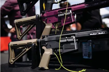  ?? Photograph: Patrick T Fallon/AFP/Getty Images ?? AR-15 style rifles are displayed for sale at a gun show in Costa Mesa, California, in 2021.