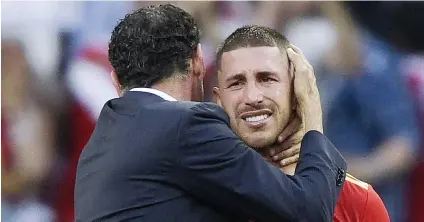  ?? Picture: AFP ?? THE DREAM DIES. Spanish defender Sergio Ramos is consoled by coach Fernando Hierro after their World Cup last-16 defeat to Russia at the Luzhniki Stadium in Moscow on Sunday.