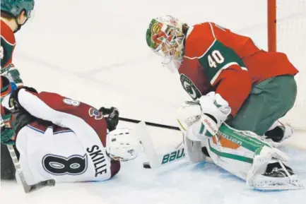  ??  ?? MinnesotaW­ild goalie Devan Dubnyk stops a shot by Avalanche right wing Jack Skille during the first period Tuesday night. Dubnyk made 30 saves in the game. Skille had three shots on goal, did not score but had an assist. Ann Heisenfelt, The Associated...
