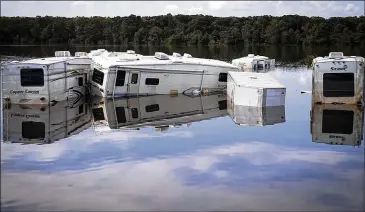  ?? PHOTOS BY NICK WAGNER / AMERICAN-STATESMAN ?? RV homes submerged by floodwater­s from Hurricane Harvey sit to the north of Interstate 10 in the Orange County town of Vidor on Tuesday. Large portions of Southeast Texas remain flooded after Harvey brought record rains to the Houston area. Many homes...