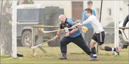  ??  ?? Lovat’s Lewis Tawse sqeezes the ball past Kingussie keeper Craig Dawson for the first goal during their cottages.com MacTavish Cup tie held at Balgate last Saturday which the home side won 3-1.