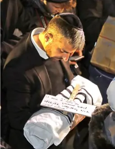  ?? — AFP photo ?? Relatives of Israeli couple Amichai and Shira Ish-Ran attend the funeral of their baby at the Jewish cemetery on the Mount of Olives in front of Jerusalem’s Old City.