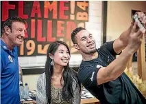  ??  ?? Above, Kiwi heavyweigh­t boxer Joseph Parker takes a selfie with a fan and trainer Kevin Barry, left, in Auckland. Below, Parker relaxes with his father Dempsey.