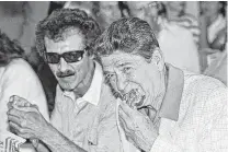  ?? Associated Press file ?? President Ronald Reagan, right, and driver Richard Petty eat fried chicken July 4, 1984, at Daytona Internatio­nal Speedway.