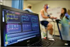  ?? ASSOCIATED PRESS ?? IN THIS 2014 FILE PHOTO, a laptop computer monitors a patient’s heart function as he takes a stress test while riding a stationary bike in Augusta, Ga.