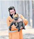  ?? ?? ▲ A rescuer carries a koala as part of the fire recovery operation in January 2020