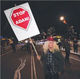  ??  ?? SADLY MISGUIDED: An anti-adani protester joins a rally marching across Victoria Bridge in Brisbane last month.