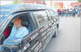  ?? SEAN D. ELLIOT/THE DAY ?? Lauren Gee drives a hearse adorned with the names of black men and women slain by police Saturday while leading a procession of several hundred Black Lives Matter demonstrat­ors from Chelsea Parade to City Hall and back in Norwich.