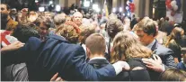  ??  ?? Supporters of Roy Moore, the Republican candidate for U.S. Senate, pray at the Tuesday election night gathering in Montgomery, Ala. The sight of white evangelica­l voters in Alabama giving support to Moore, despite accusation­s of racial and religious...