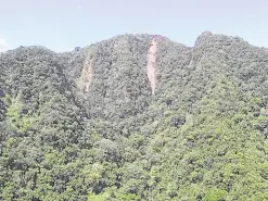  ?? —MGB AND PAMPANGA PDRRMO PHOTO ?? SCARRED This aerial shot of the summit of Mt. Arayat on Nov. 10 shows two gashes left by landslides that struck the Pampanga mountain’s protected area.