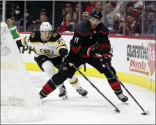  ?? AP ?? RETURNING TO ACTION: Bruins defenseman Charlie McAvoy chases Carolina’s Jordan Staal during the second period of Game 5 on Tuesday night in Raleigh, N.C.