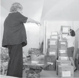  ??  ?? Donna Lupschutz, left, directs Mischa Greenberg, owner of Moves-Made-EZ, at Lupschutz’s home.